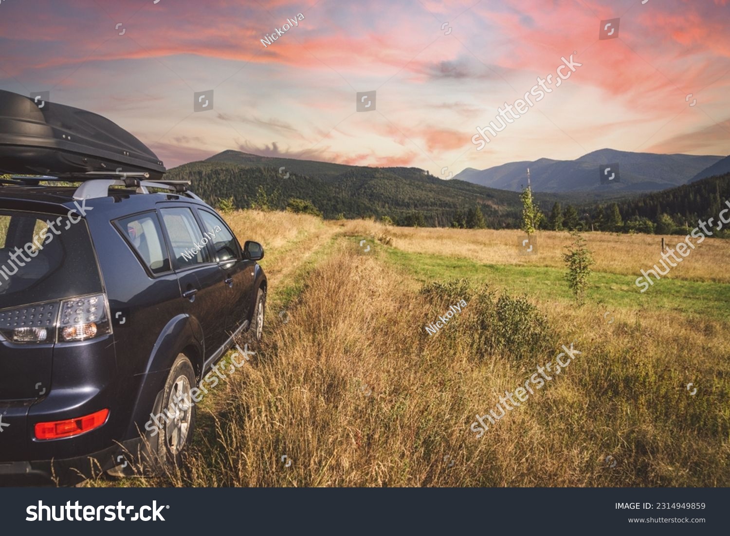 car for traveling with a mountain road. Dramatic sky #2314949859