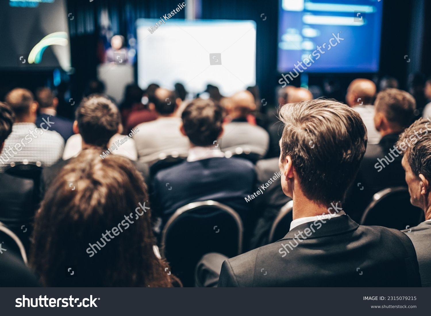 Speaker giving a talk in conference hall at business event. Rear view of unrecognizable people in audience at the conference hall. Business and entrepreneurship concept #2315079215