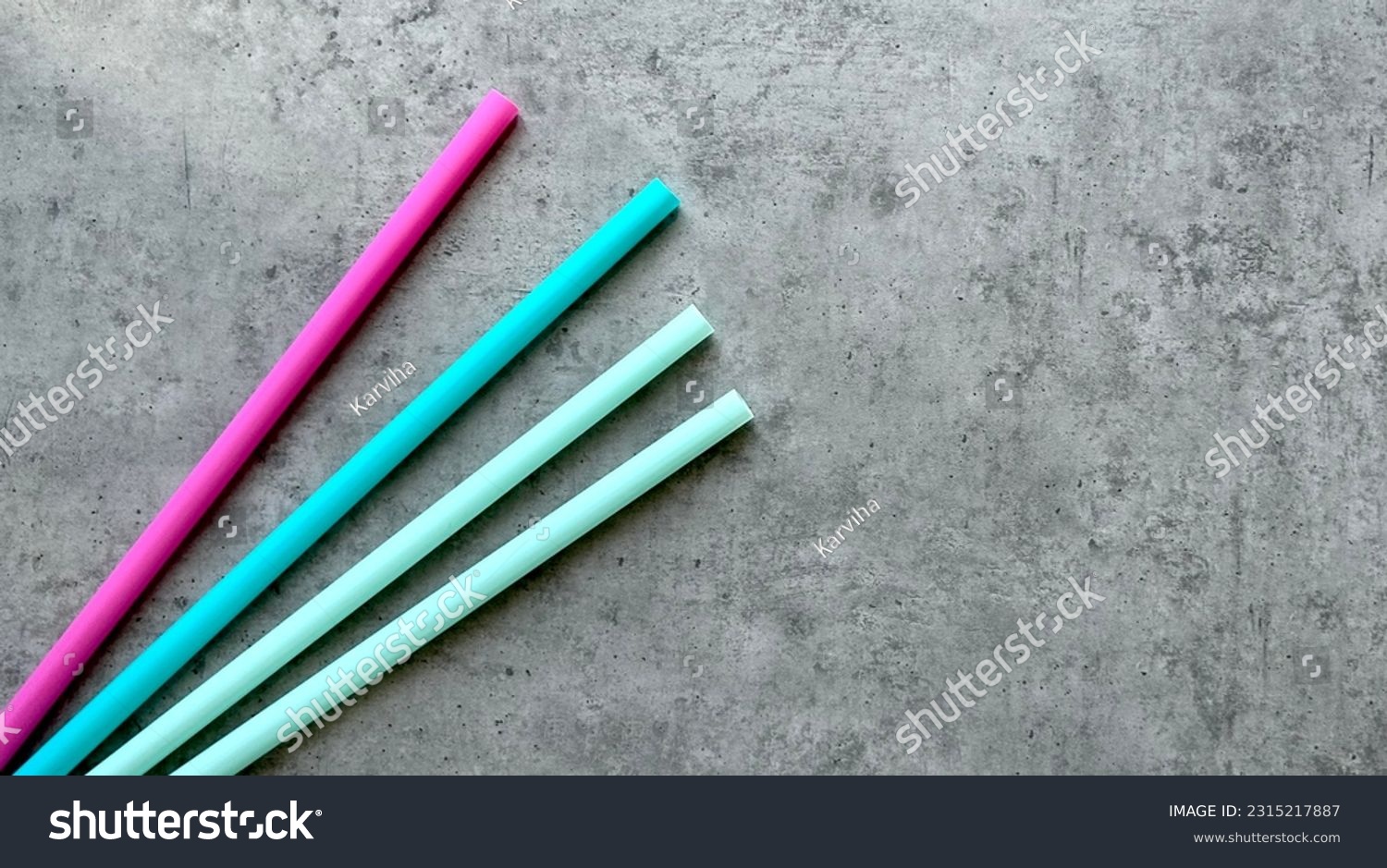 colored plastic straws for drinking on a gray background #2315217887