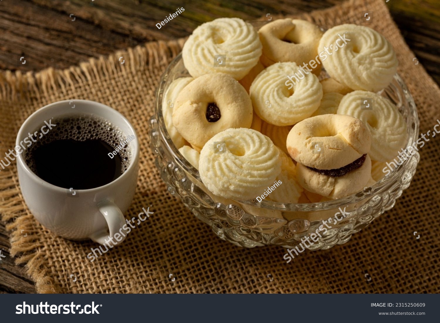 

Delicious mini butter flavored milk and (Sequilhos) guava cookies with a cup of coffee served in elegant jars on top of a rustic wood or white marble table, top view and selective focus #2315250609