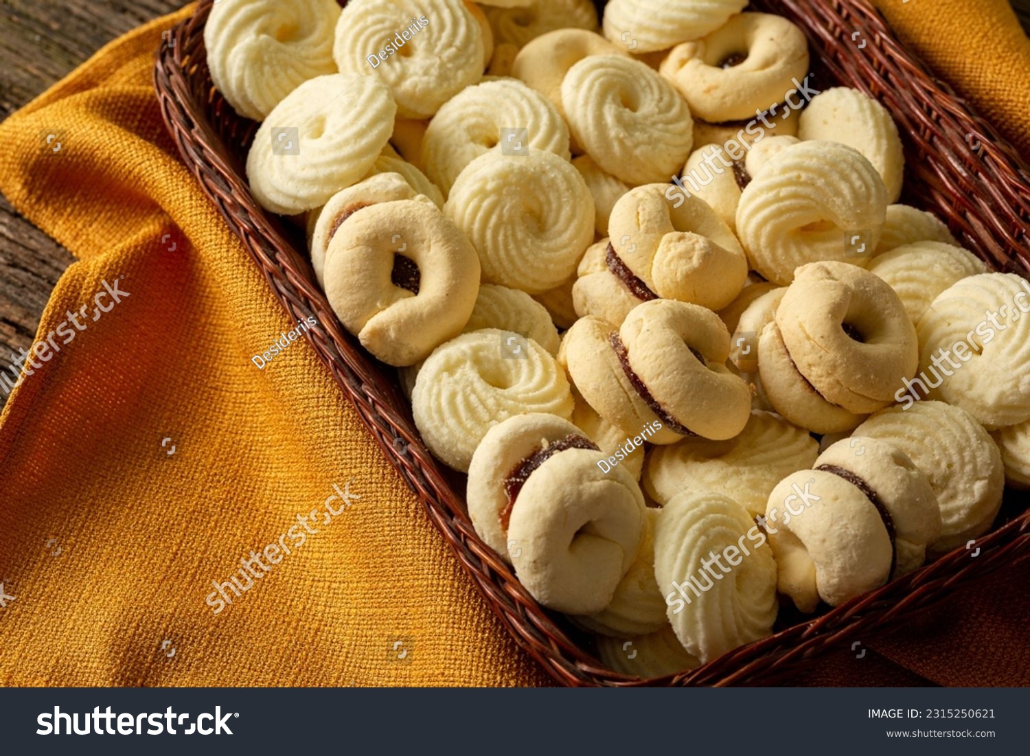 

Delicious mini butter flavored milk and (Sequilhos) guava cookies with a cup of coffee served in elegant jars on top of a rustic wood or white marble table, top view and selective focus #2315250621