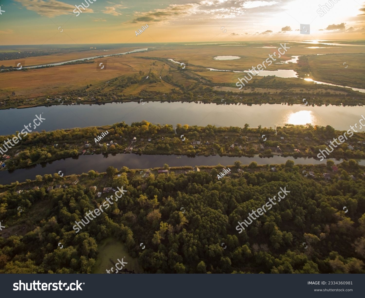 Aerial view of the river, forest and fields in the light of the rising sun. Kherson region, Kherson, Ukraine. #2334360981