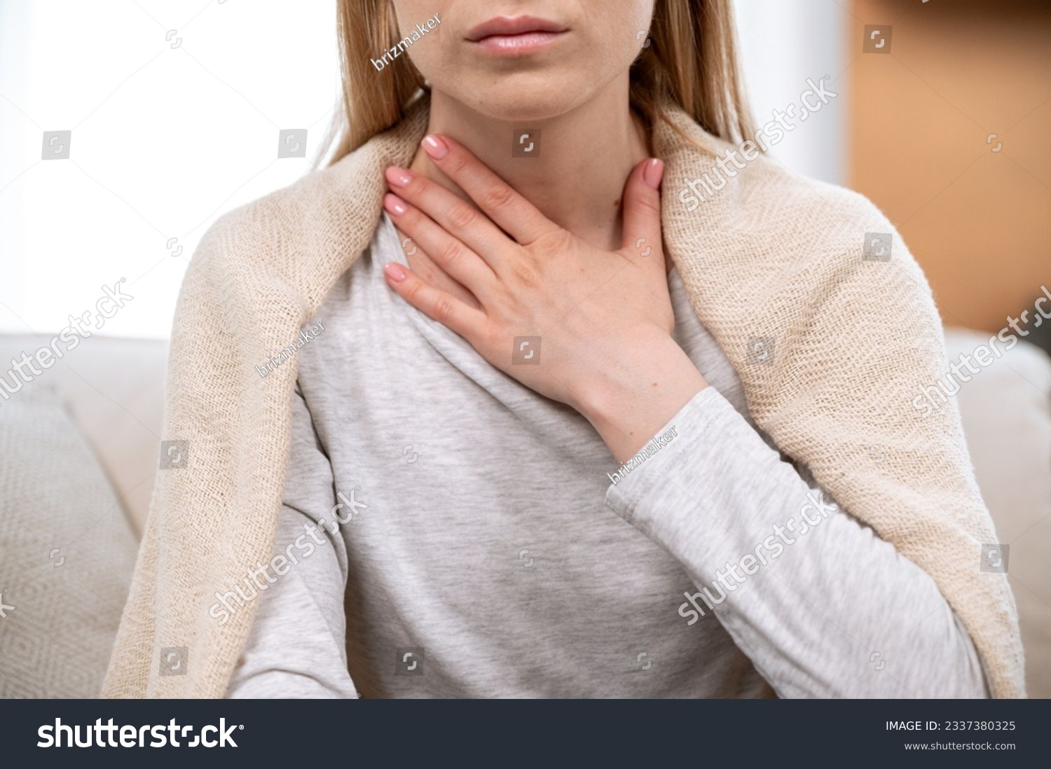 Close up view of female hand on neck, suffering from sore throat. Cropped view of sick woman feel discomfort in chest, painful, difficult to swallow. Concept of tonsillitis, angina, pectoris #2337380325
