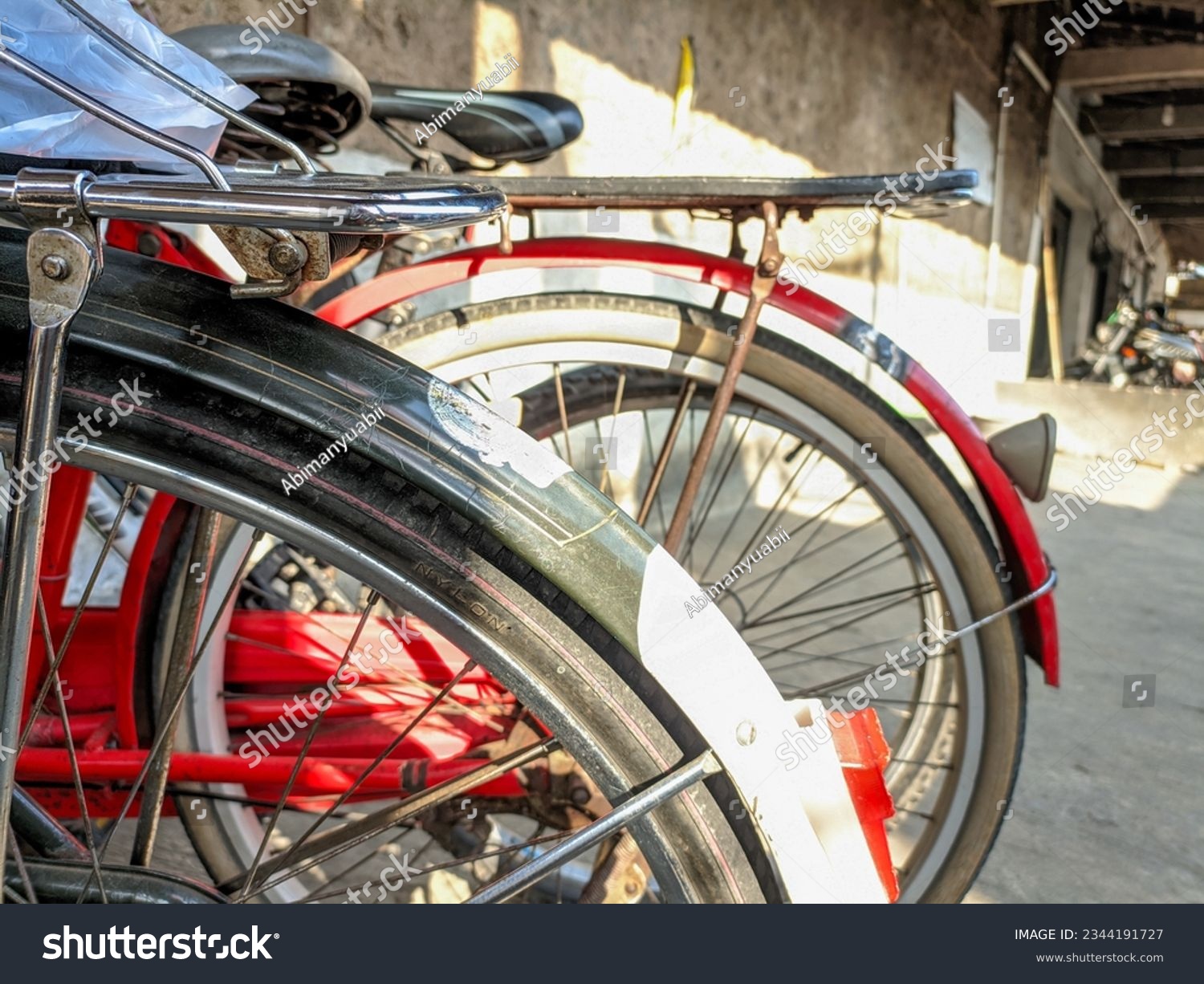 An old Dutch bicycle that is still well-maintained and usable. Old bicycle tires of a parked bicycle. Roadster bicycle, Camel, Buffalo. Selective focus.  #2344191727