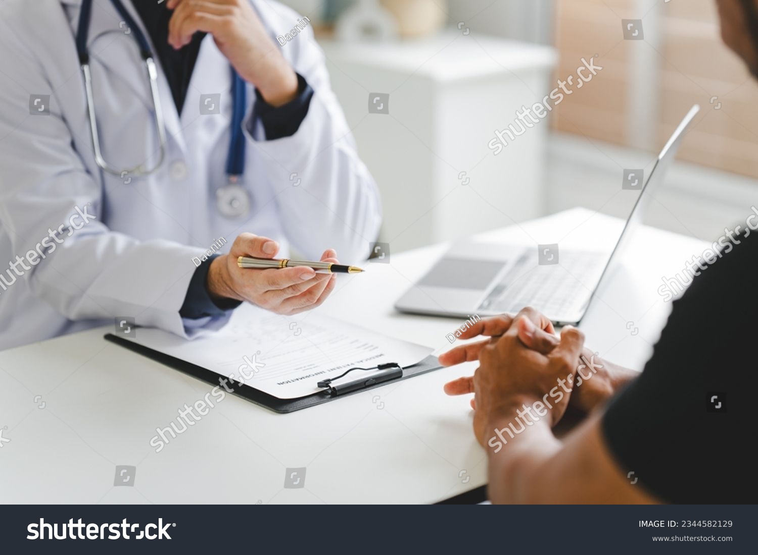 Doctor talking to patient and filling patient history, examination, treatment, medical and health concept.	 #2344582129