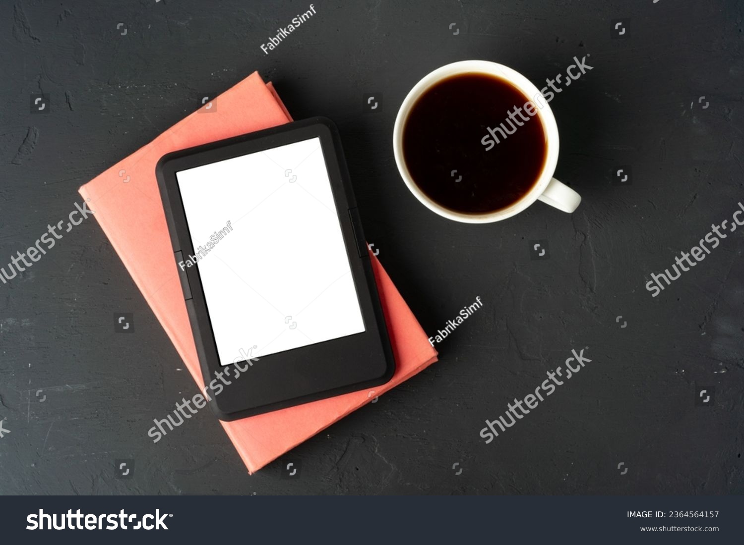 Composition with modern e-book reader, hardcover book and cup of coffee on table #2364564157