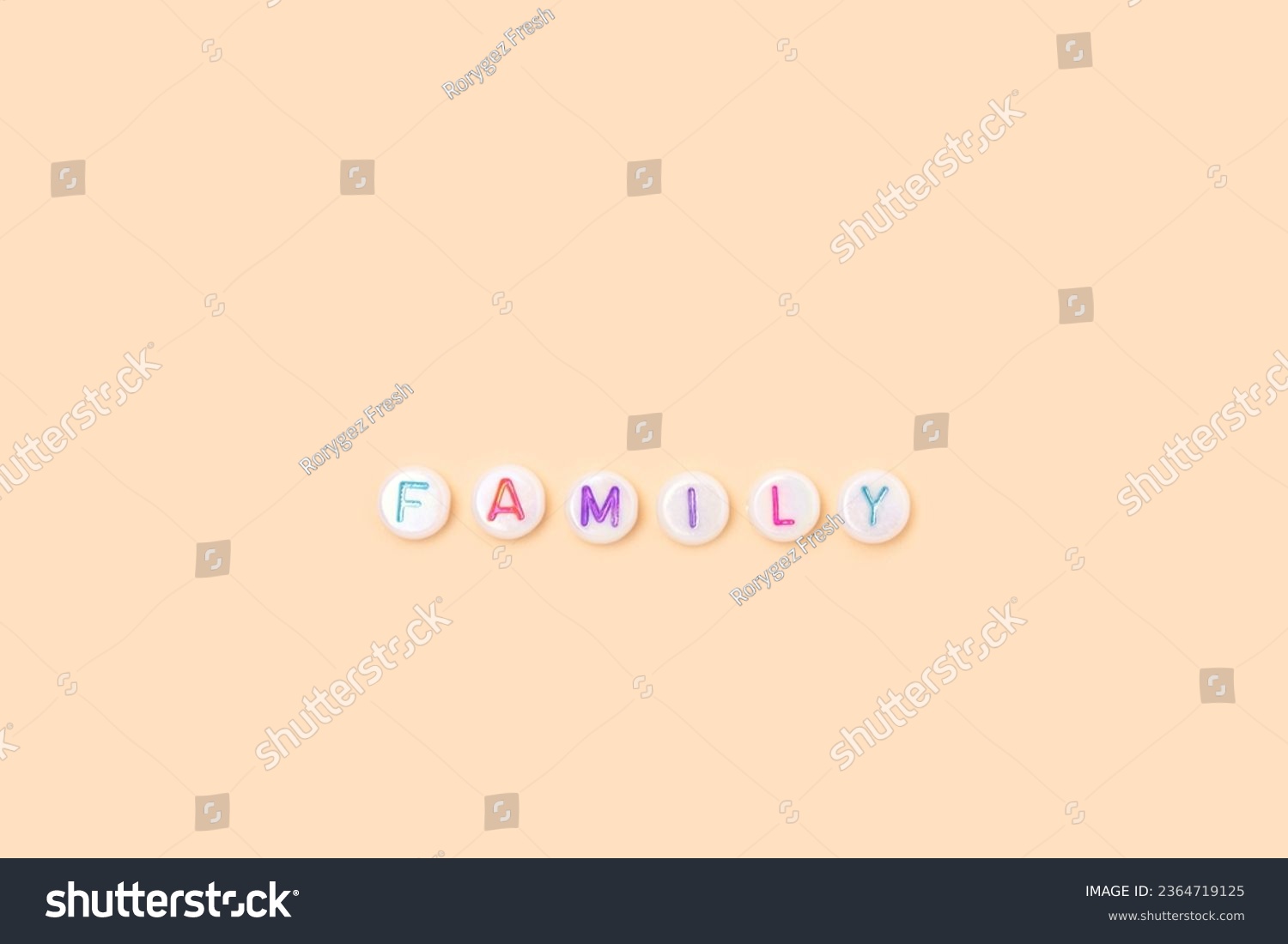Word Family. Quote made of white round beads with colorful letters on a beige background.  #2364719125