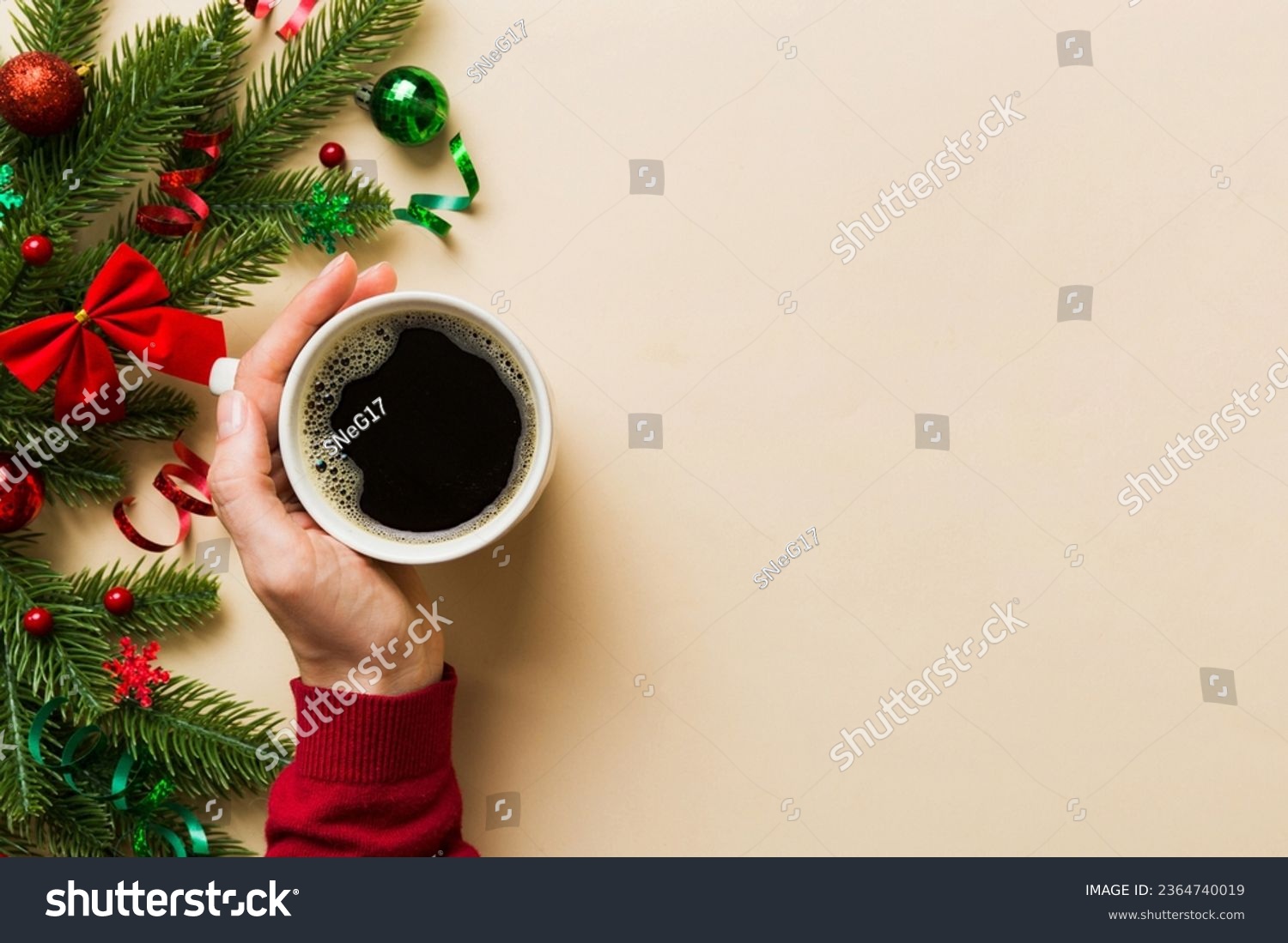 Woman holding cup of coffee. Woman hands holding a mug with hot coffee. Winter and Christmas time concept. #2364740019