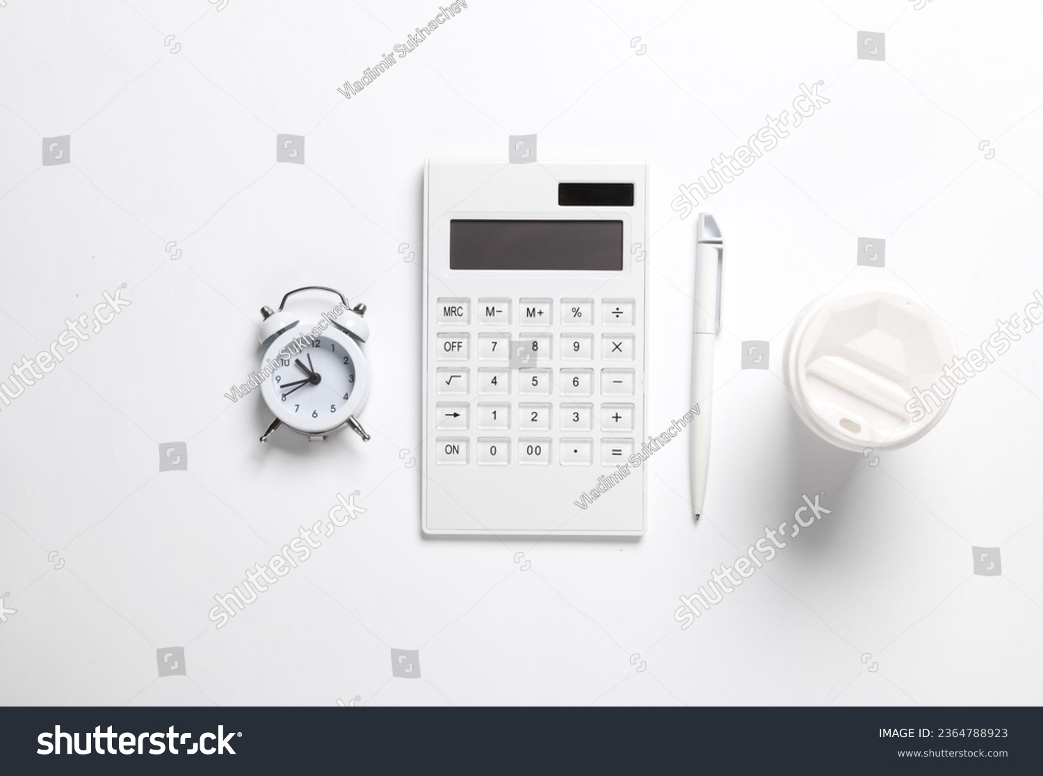 Calculator, alarm clock, pen and cup of coffee on a white background. Creative business mockup. Top view. Flat lay #2364788923