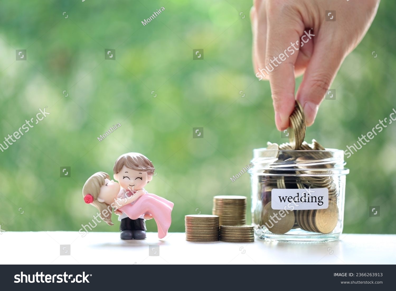 Love couple with coins money in the glass bottle on natural green background, Save money for wedding or family and save money for prepare in future concept #2366263913