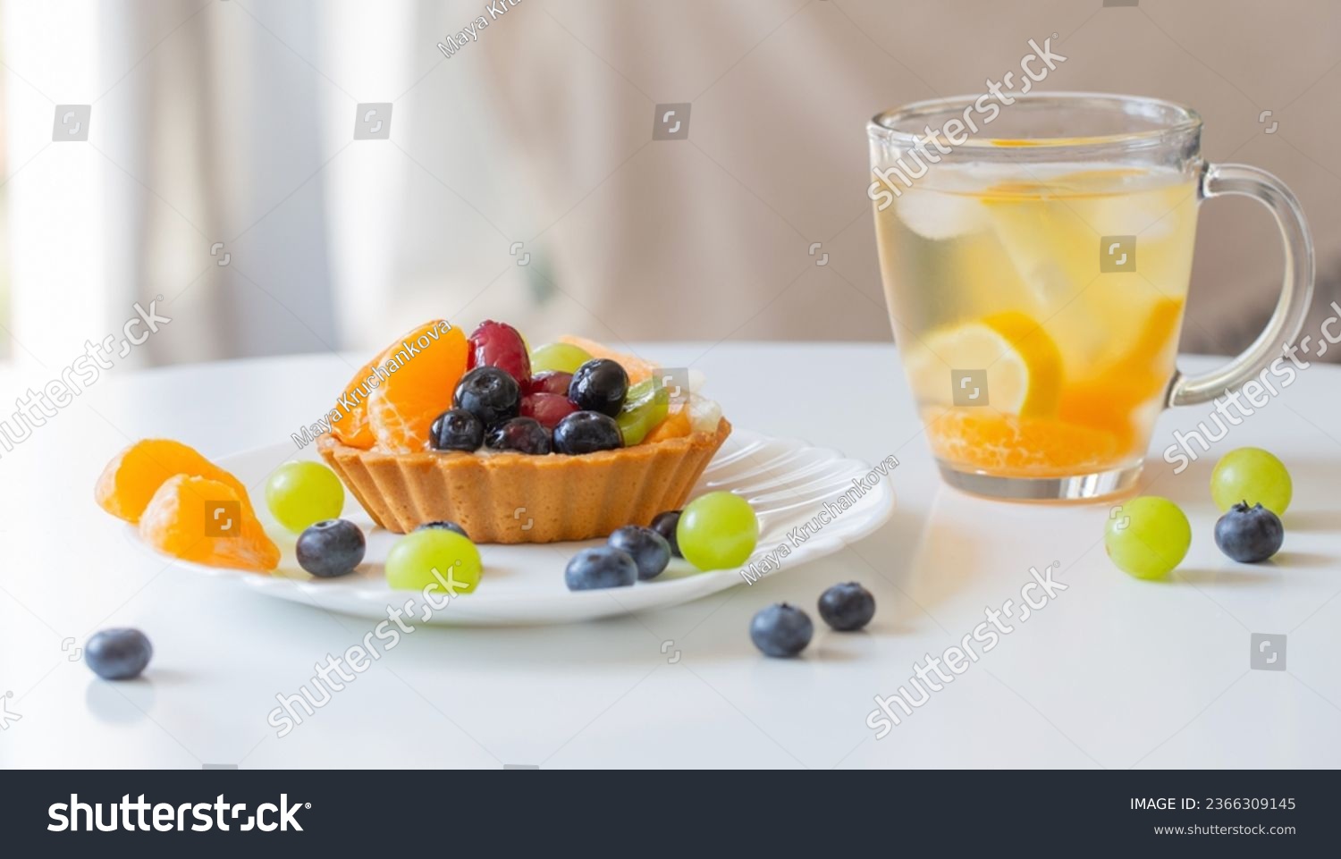 cupcakes with fruits and cold healthy drink on white  table #2366309145