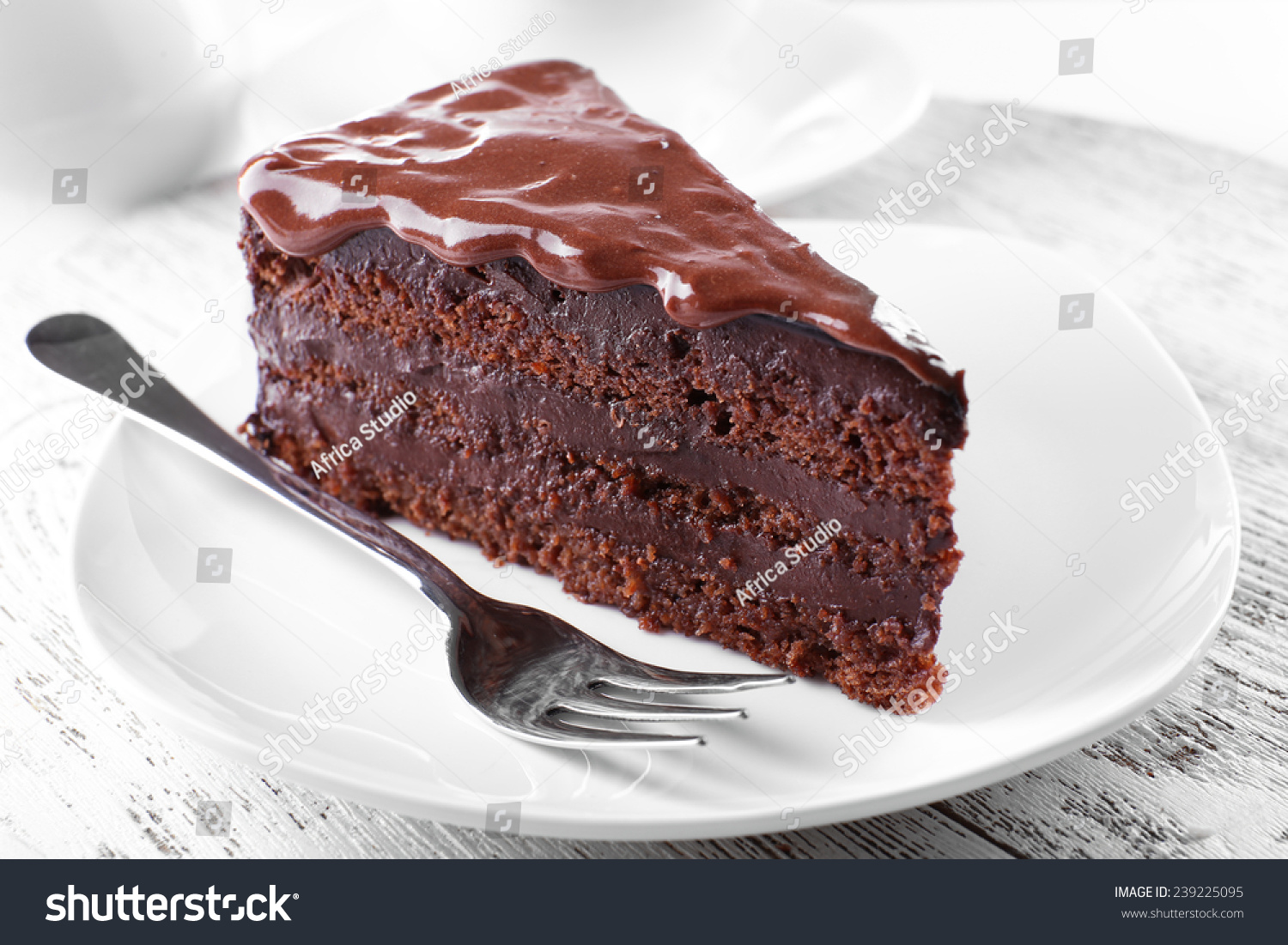 Delicious chocolate cake on plate on table on light background #239225095