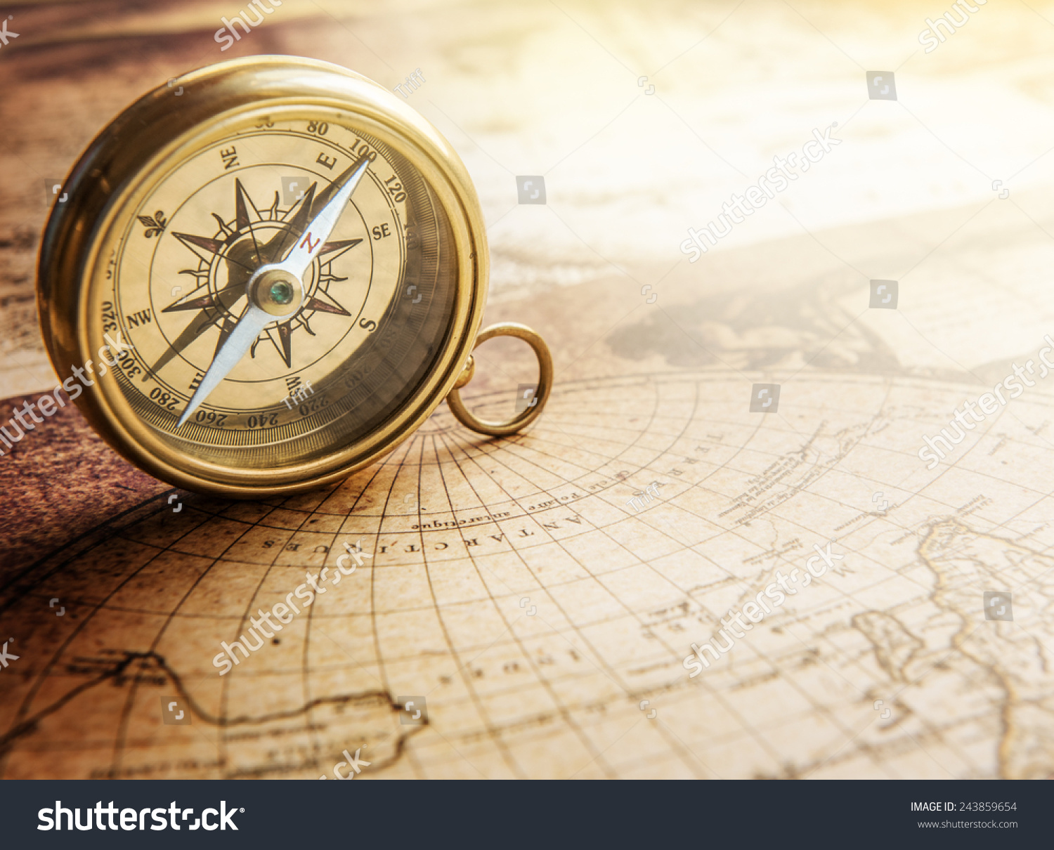 Old compass on vintage map. Retro stale. #243859654