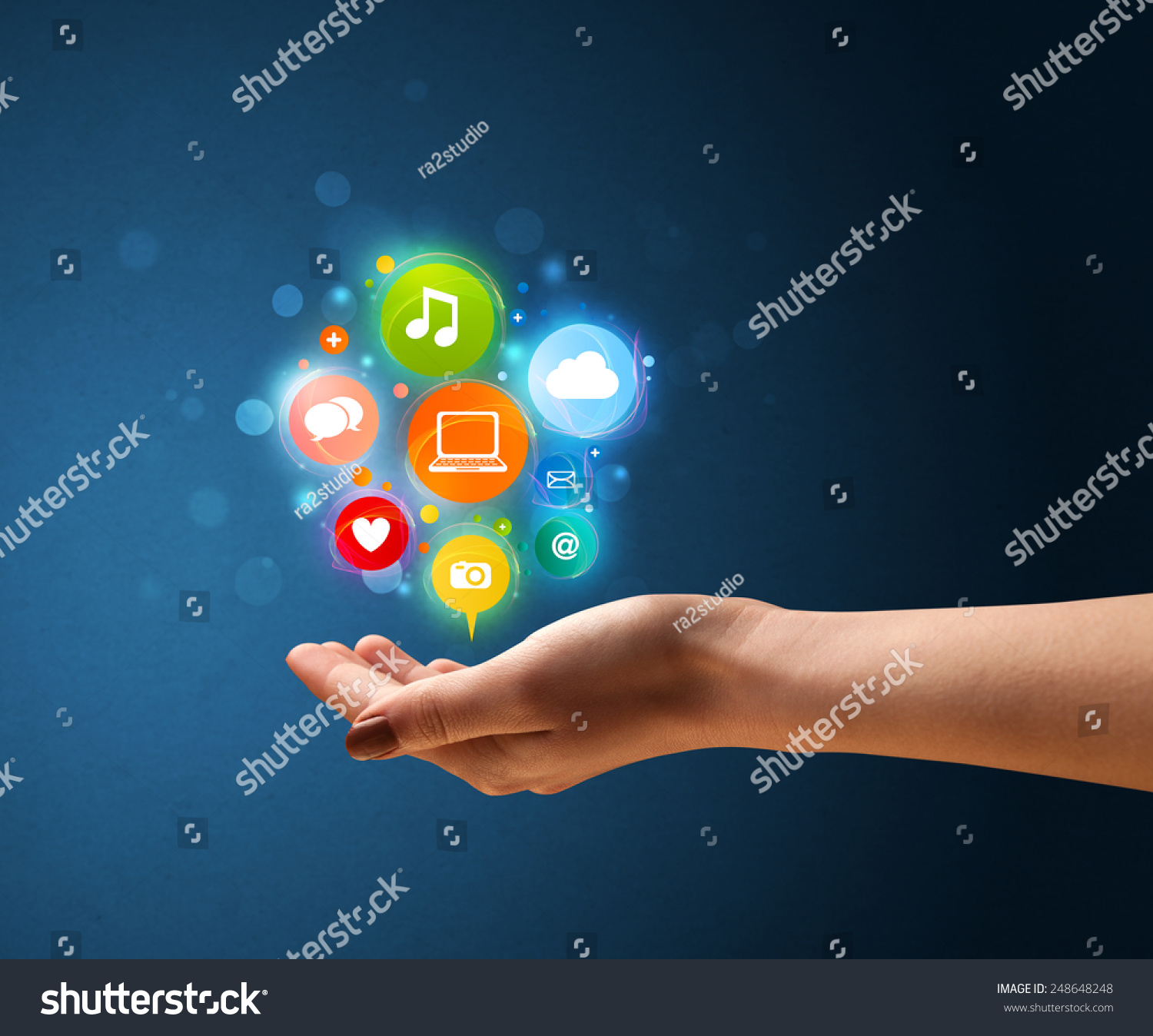 Young woman holding colorful multimedia icons in her hand #248648248
