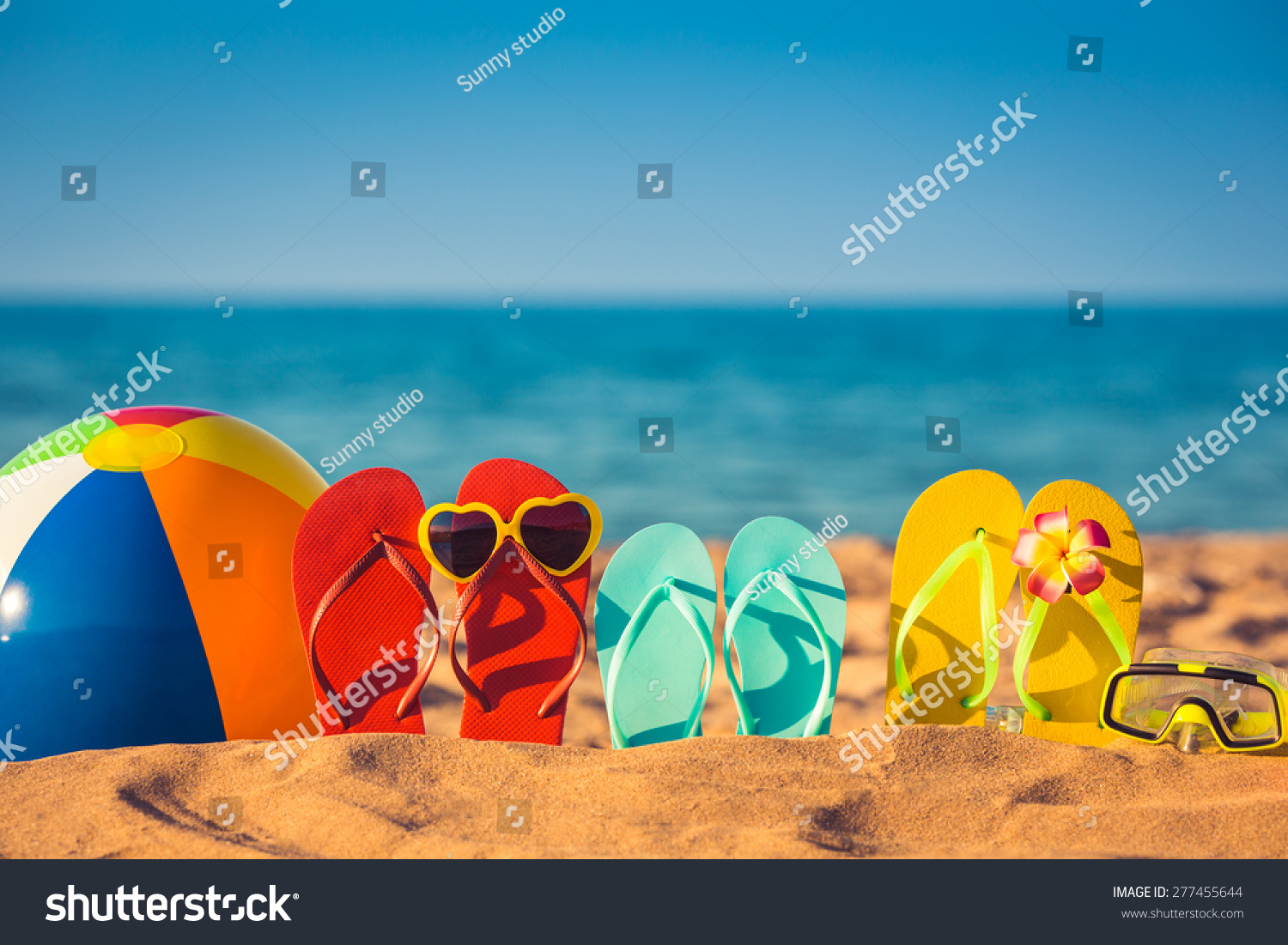 Flip-flops, beach ball and snorkel on the sand. Summer vacation concept #277455644