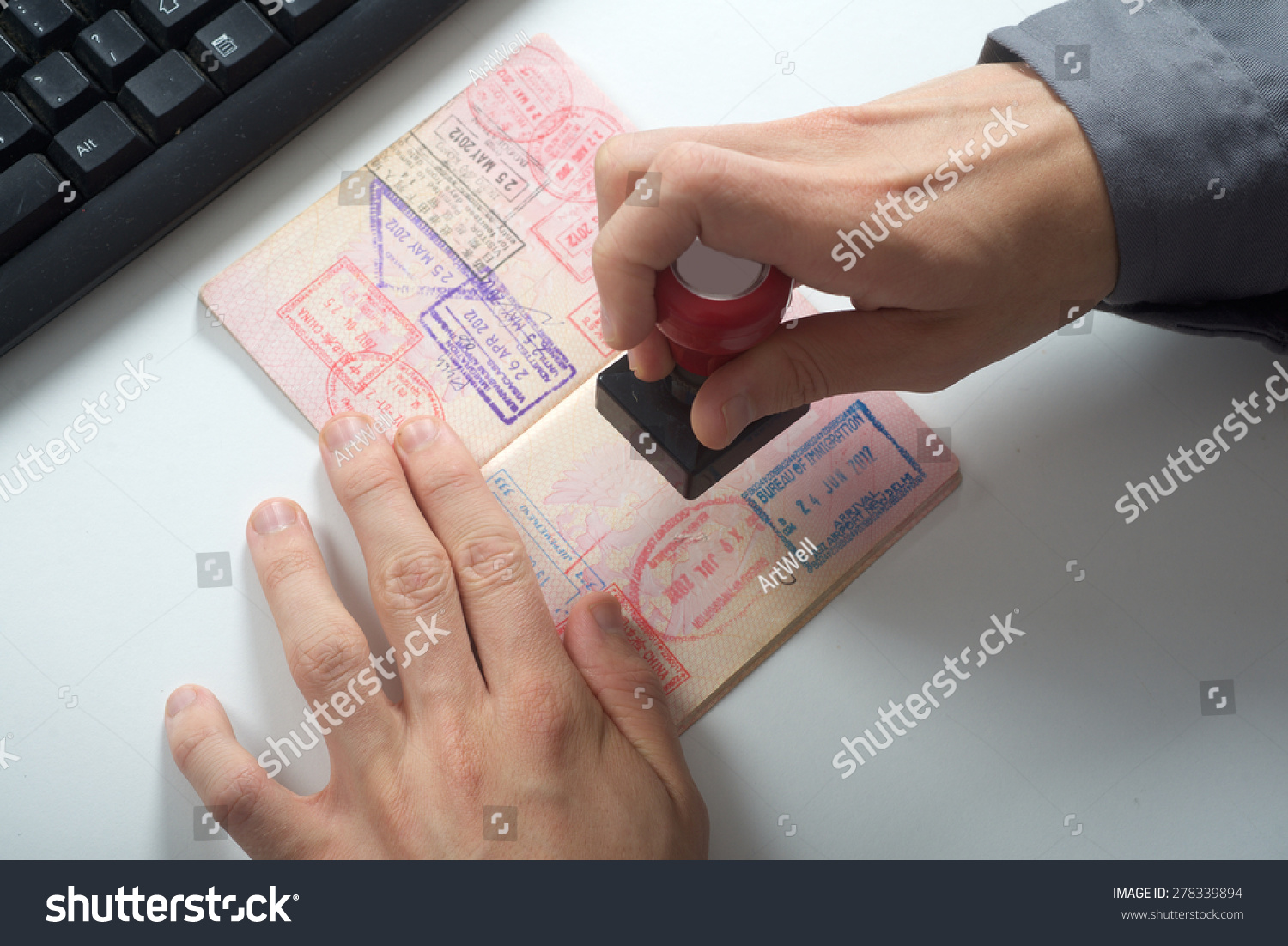 Immigration control officer will arrival stamp in the passport #278339894