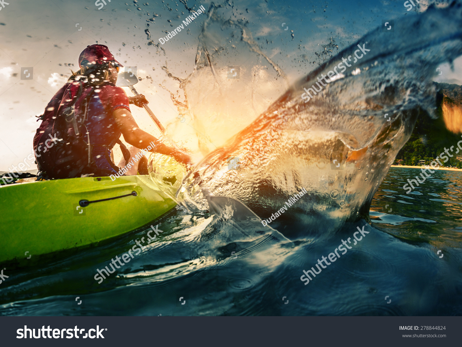 Young lady paddling hard the kayak with lots of splashes #278844824