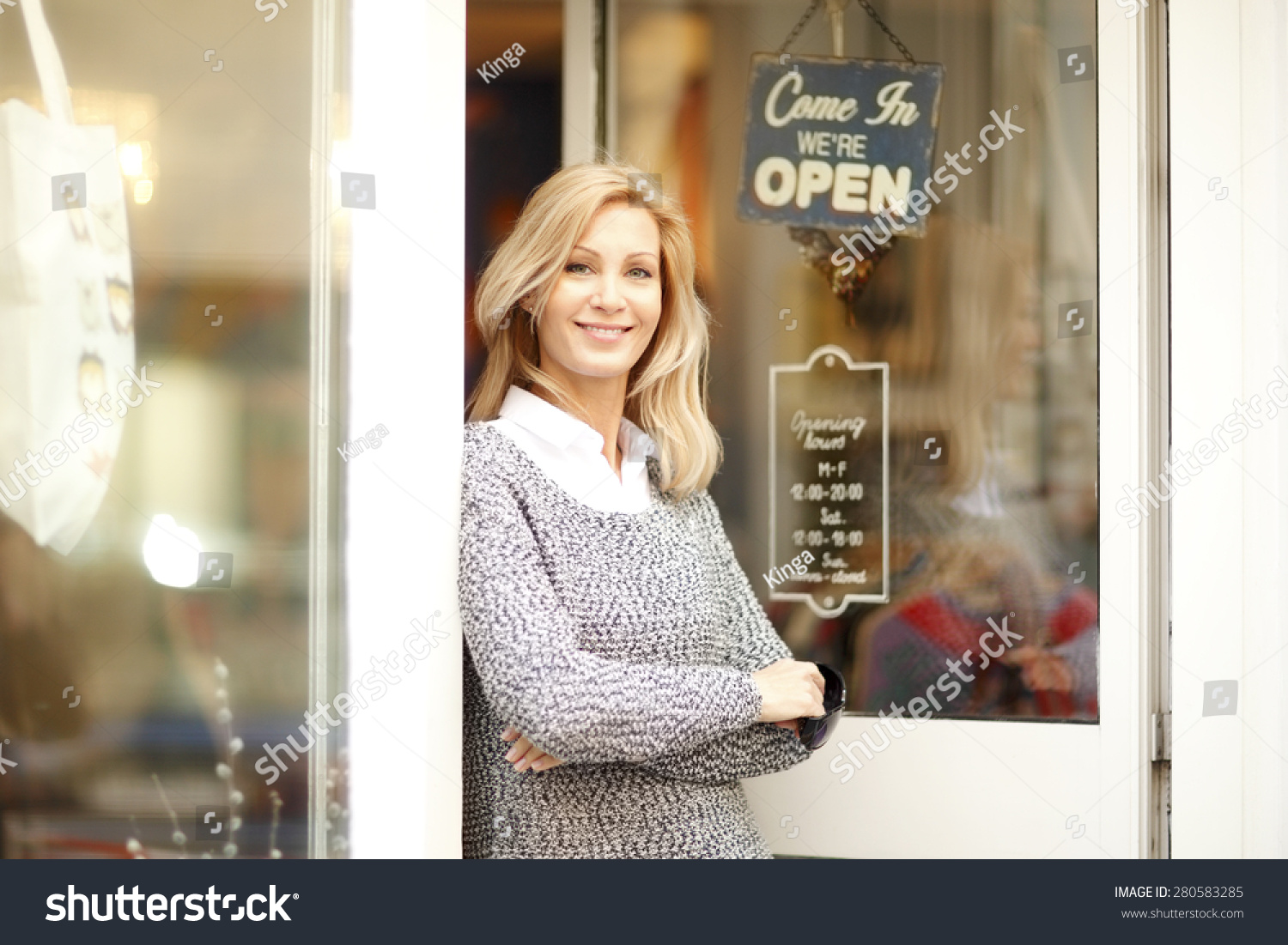 Portrait of designer woman standing in front of small vintage store. Small business. #280583285