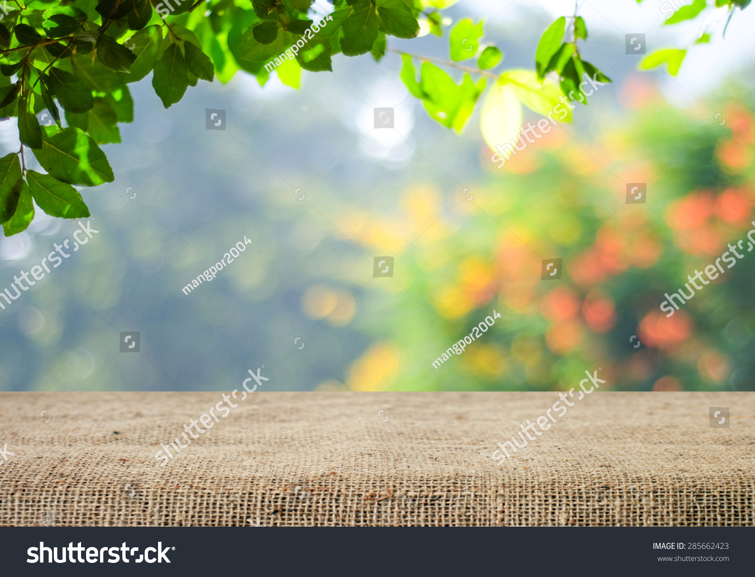 Nature background and table wood for product display template, Empty wooden table and  sack tablecloth over blur green tree at park, garden outdoor with bokeh light background #285662423