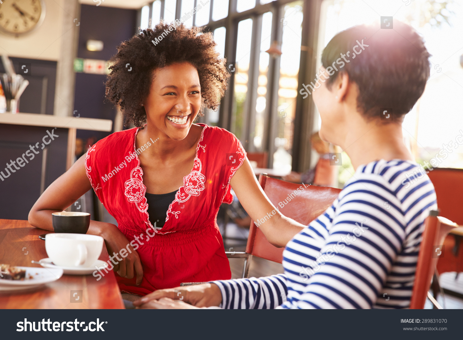 Two female friends talking at a coffee shop #289831070