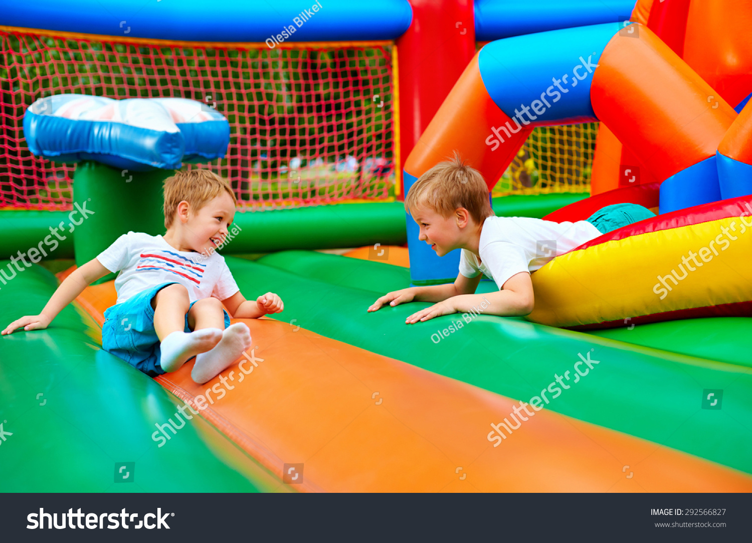 happy kids having fun on inflatable attraction playground #292566827