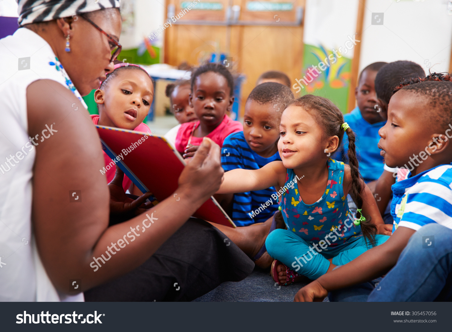 Teacher reading a book with a class of preschool children #305457056