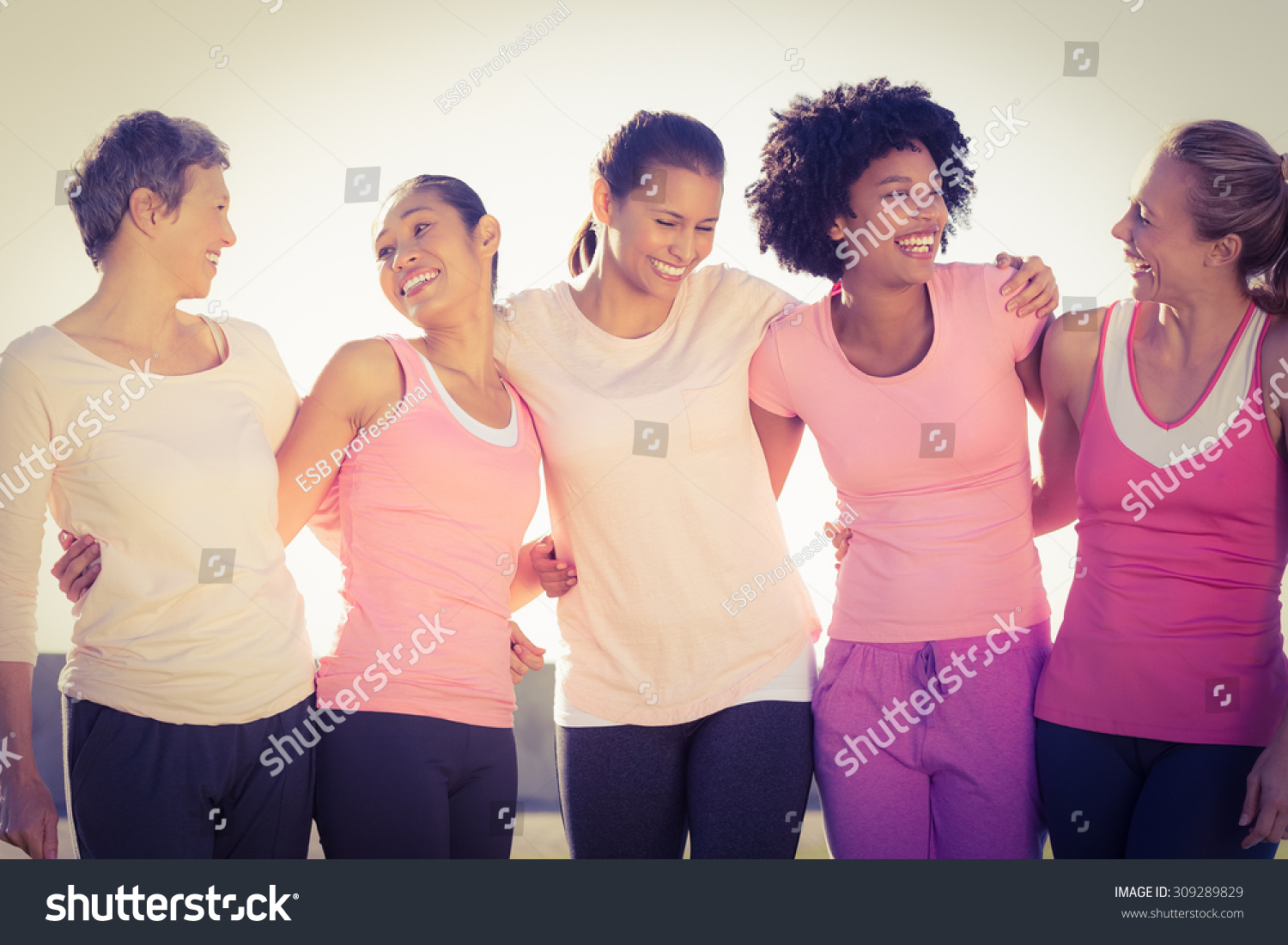 Laughing women wearing pink for breast cancer in parkland #309289829