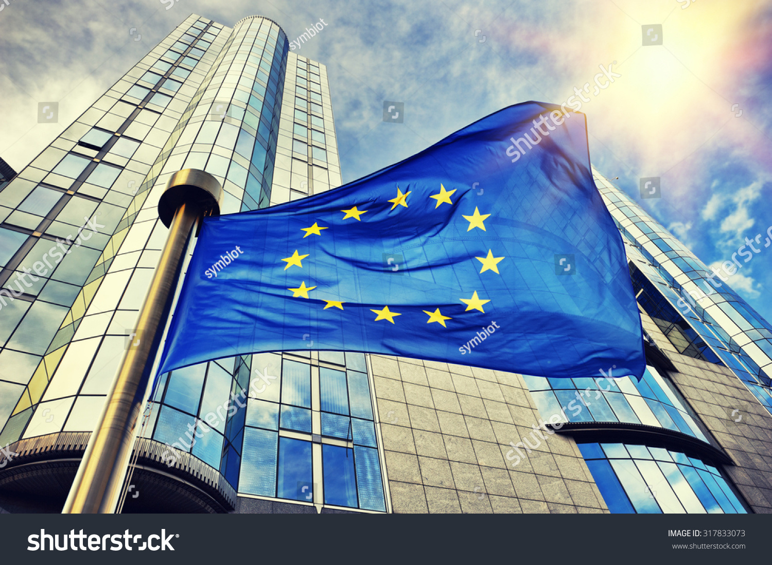 EU flag waving in front of European Parliament building. Brussels, Belgium #317833073