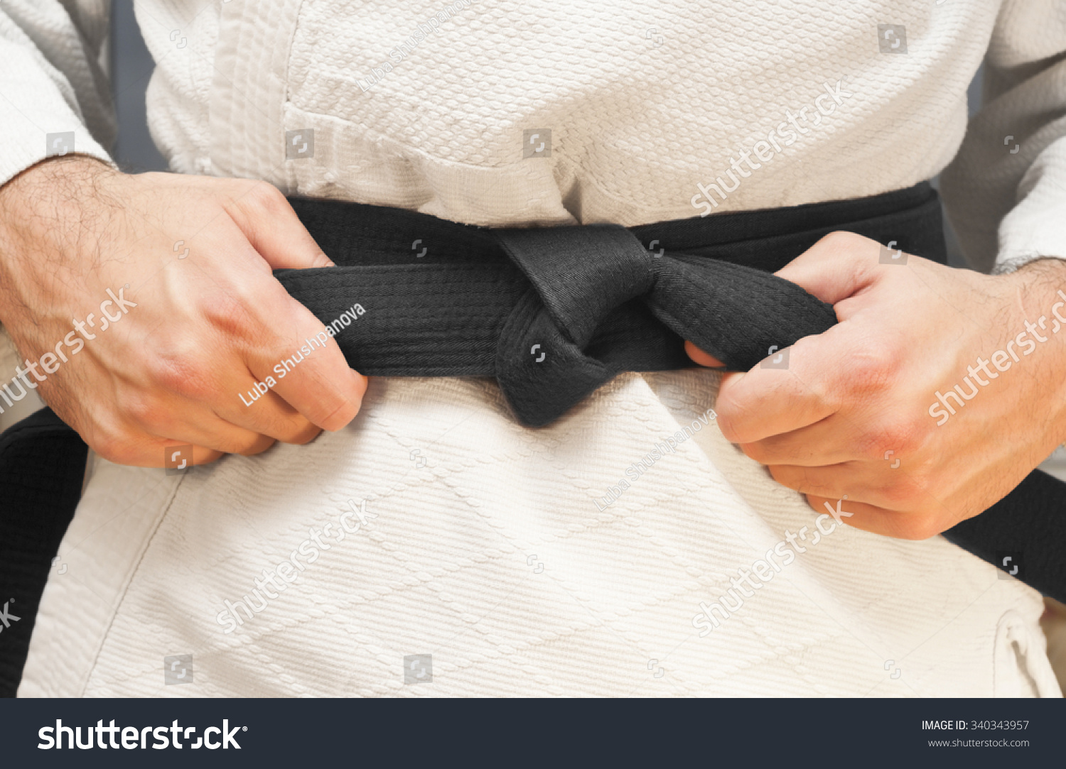 Aikido black belt on white kimono #340343957