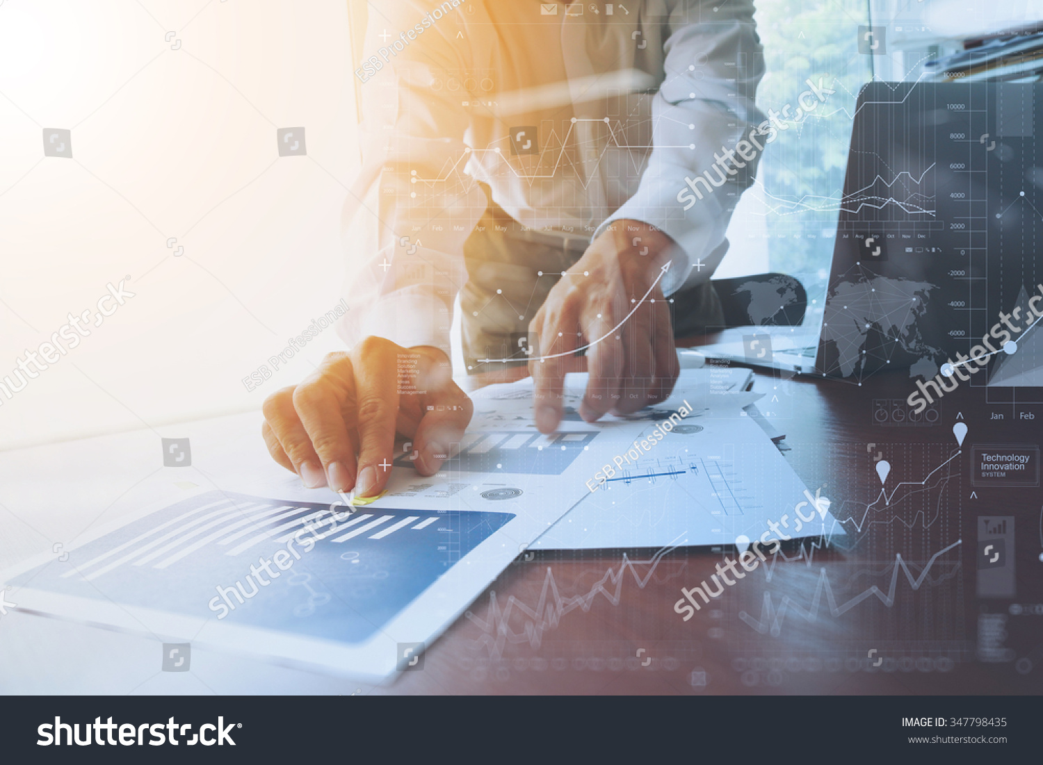 business documents on office table with smart phone and digital tablet and graph financial with social network diagram and man working in the background #347798435
