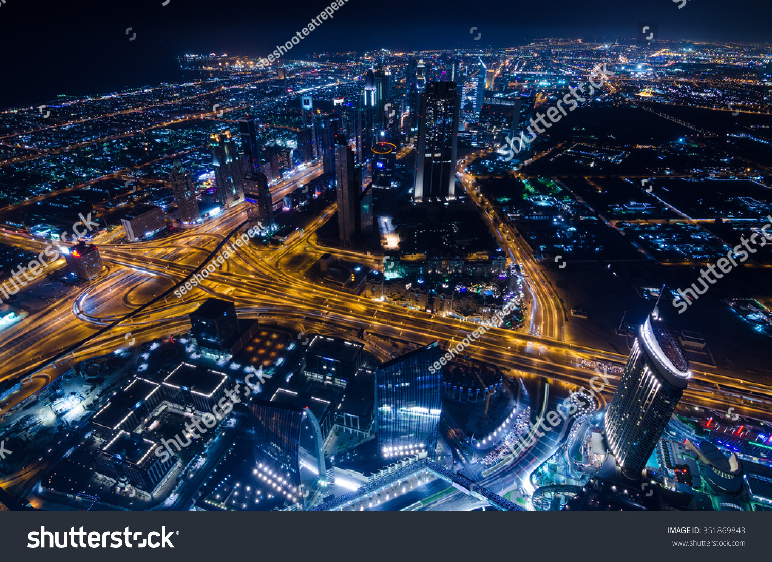 United Arab Emirates Dubai 07/14/2014 downtown dubai futuristic city neon lights and sheik zayed road shot from the worlds tallest tower building in Dubai #351869843