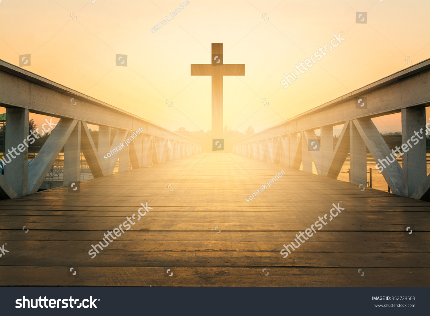 silhouette christian cross at railhead wooden bridge and orange sky with lighting,religion concept #352728503