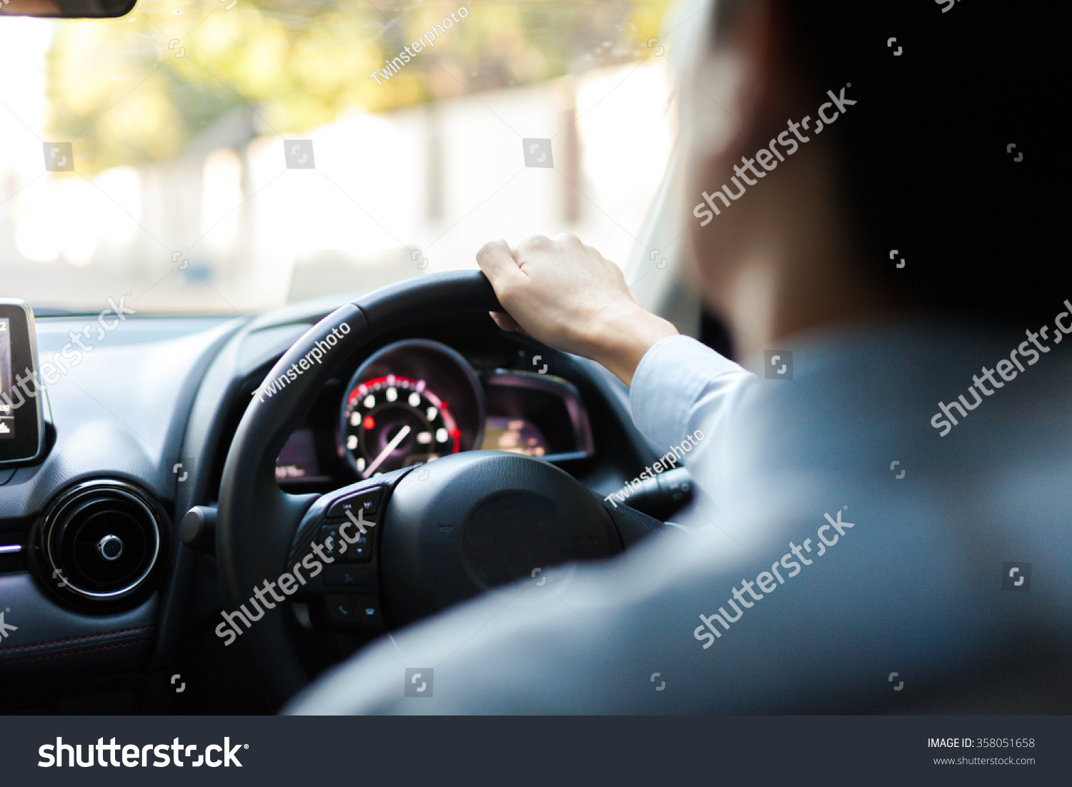 Close-up of Young man driving on the road #358051658