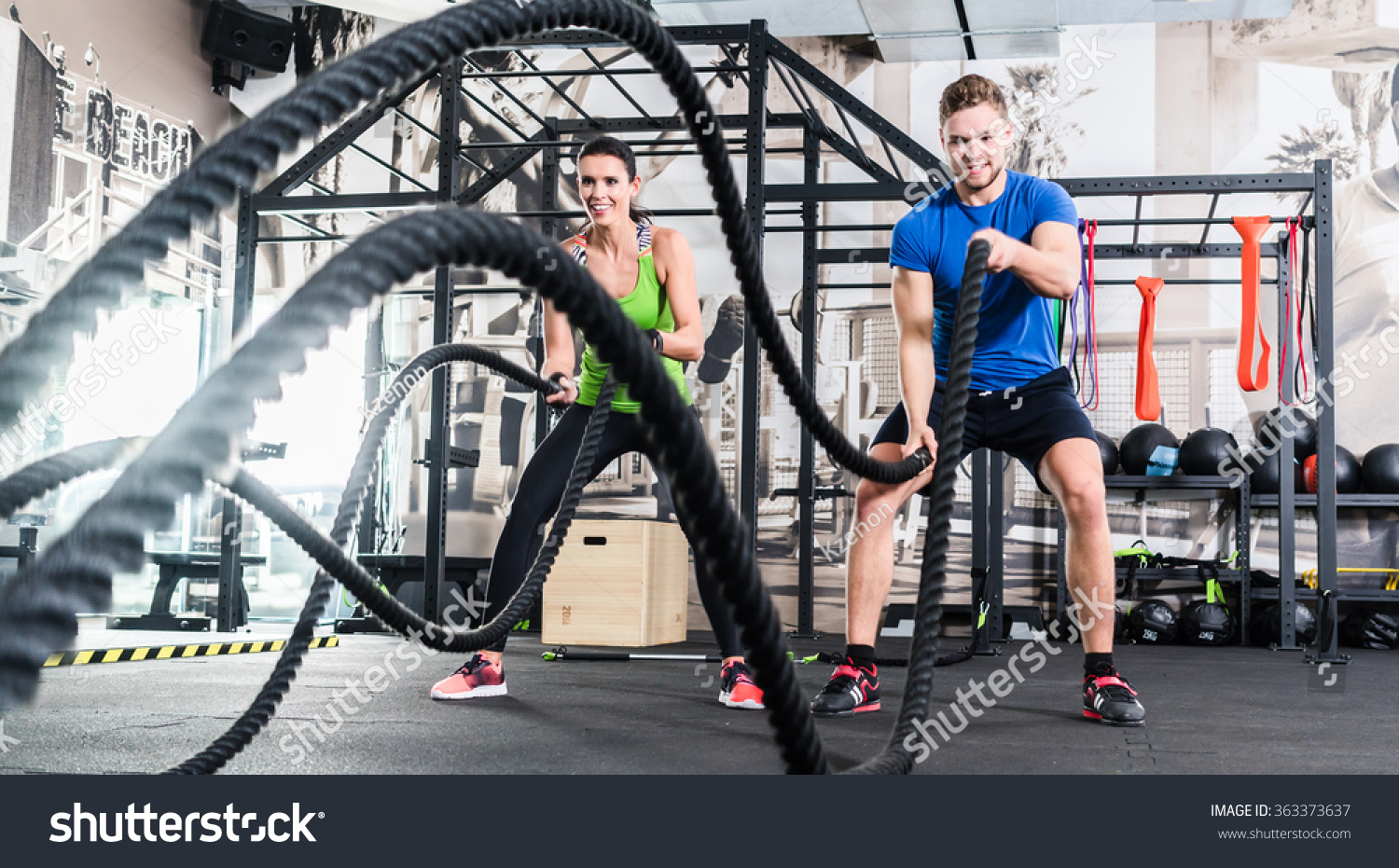 Men with battle rope in functional training fitness gym #363373637