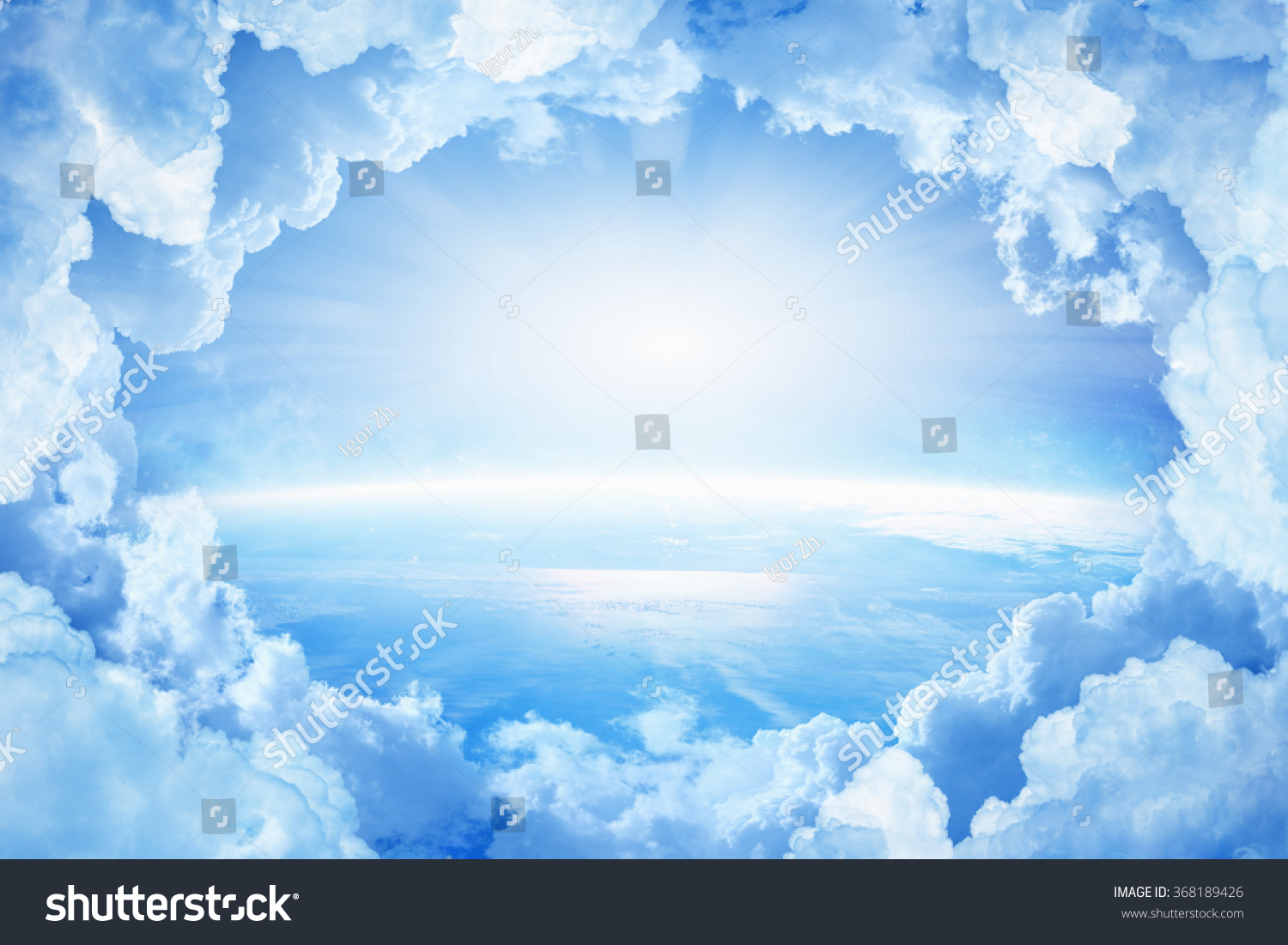 Light from heaven, blue planet Earth in white clouds, bright sunlight from above. Elements of this image furnished by NASA nasa.gov #368189426