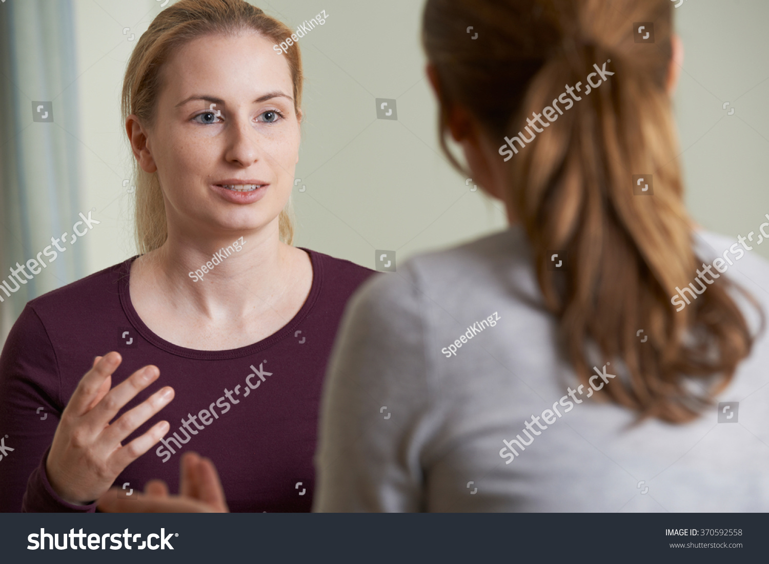 Young Woman Discussing Problems With Counselor #370592558