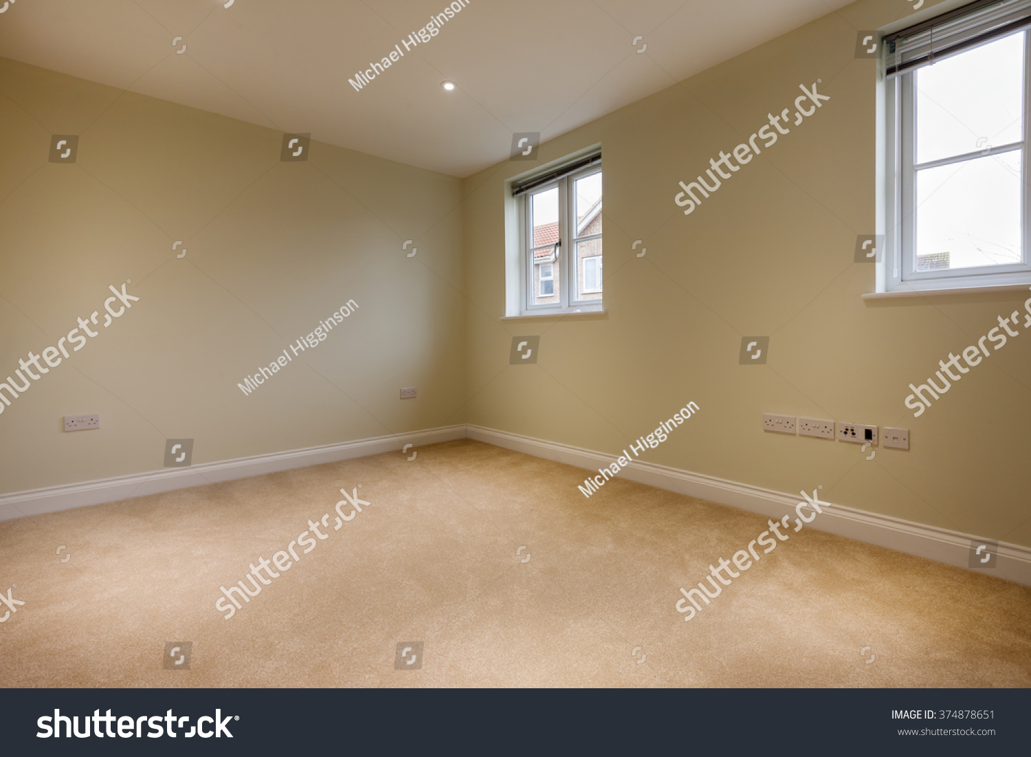 Unoccupied bedroom within brand new home with twin windows and carpet #374878651