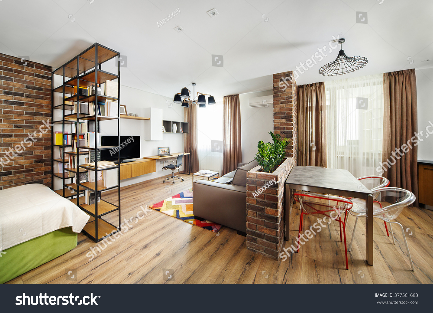 Interior studio apartments, with bookshelves and hardwood floors. #377561683