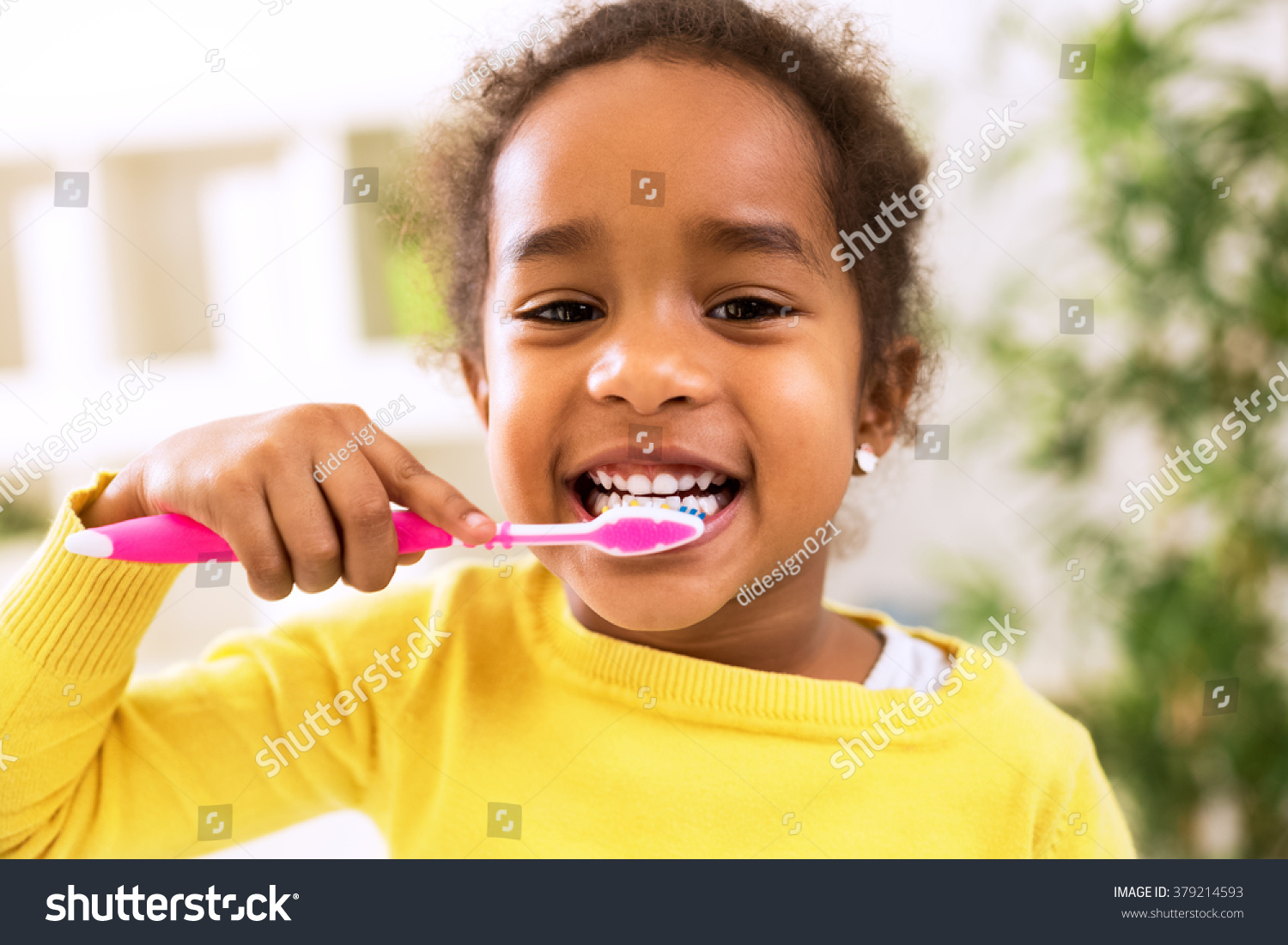 Little beautiful african girl brushing teeth, healthy concept #379214593