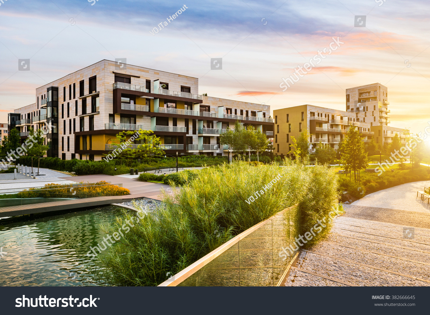 Residential building in the public green park during sunrise #382666645