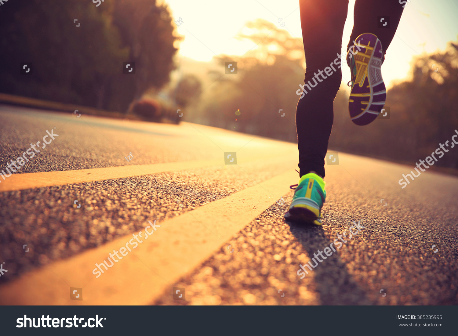 young fitness woman runner athlete running at road #385235995