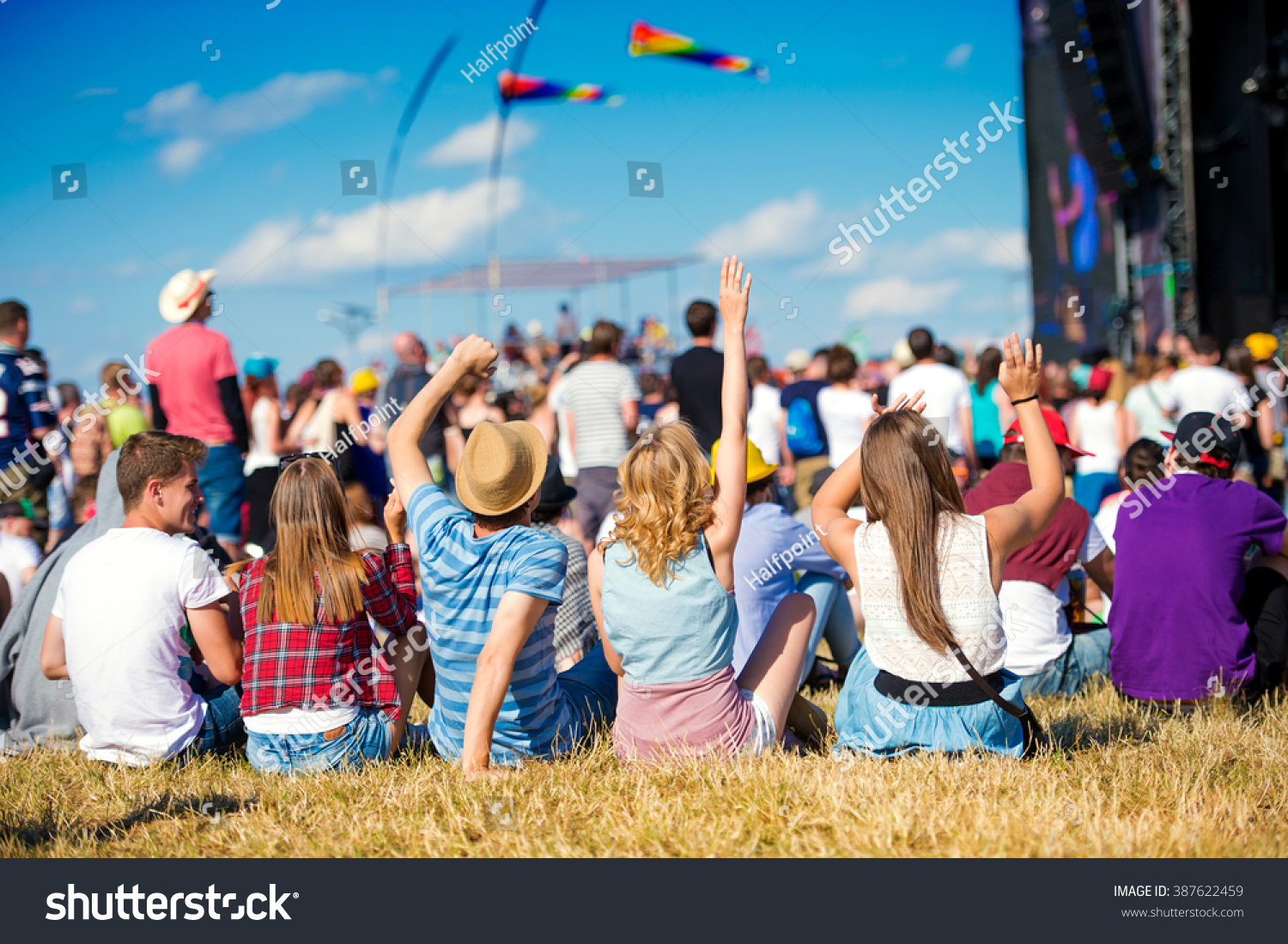 Teenagers, summer music festival, sitting in front of stage #387622459