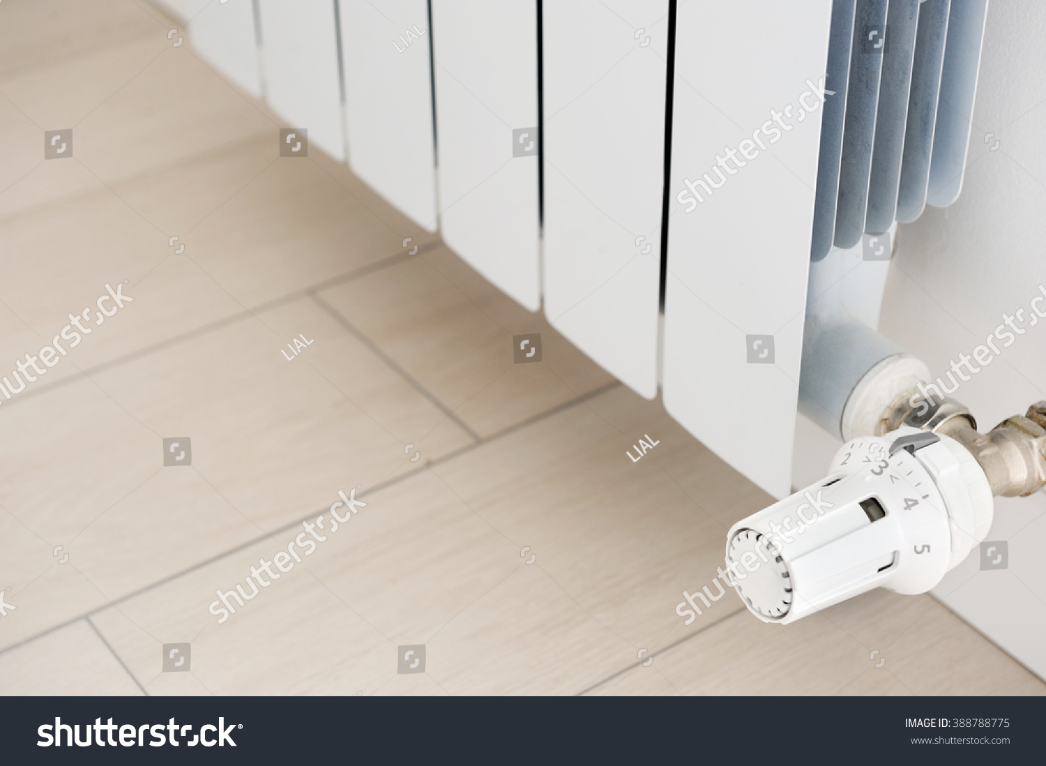 White radiator in an apartment. Radiator. #388788775