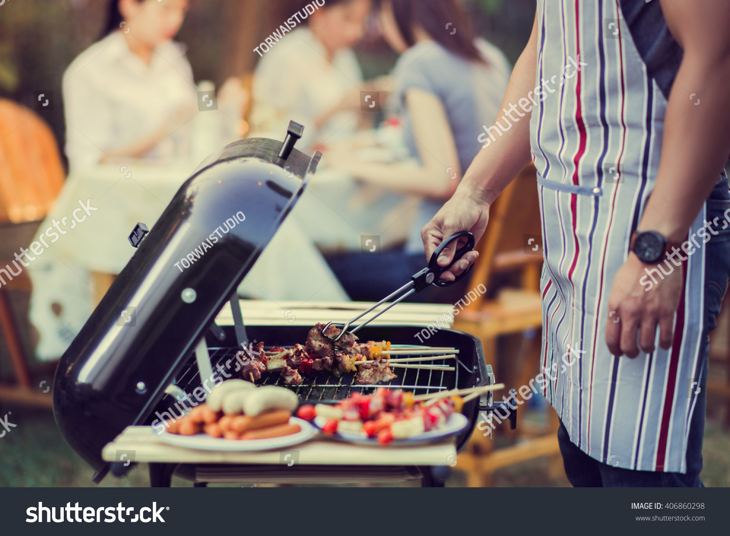 Asian men are cooking for a group of friends to eat barbecue #406860298