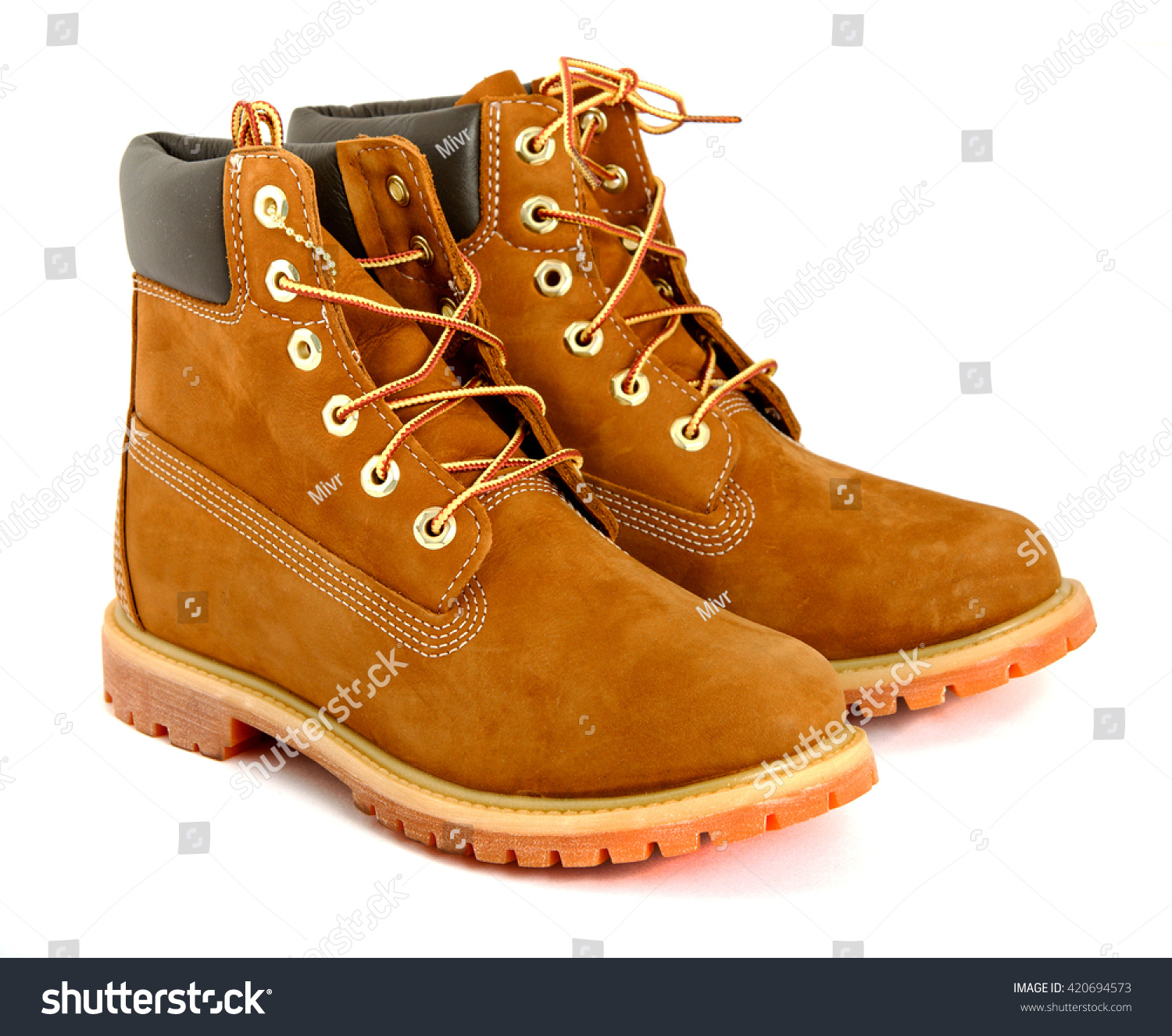 Brown lady's boots with shoelace on white background. #420694573