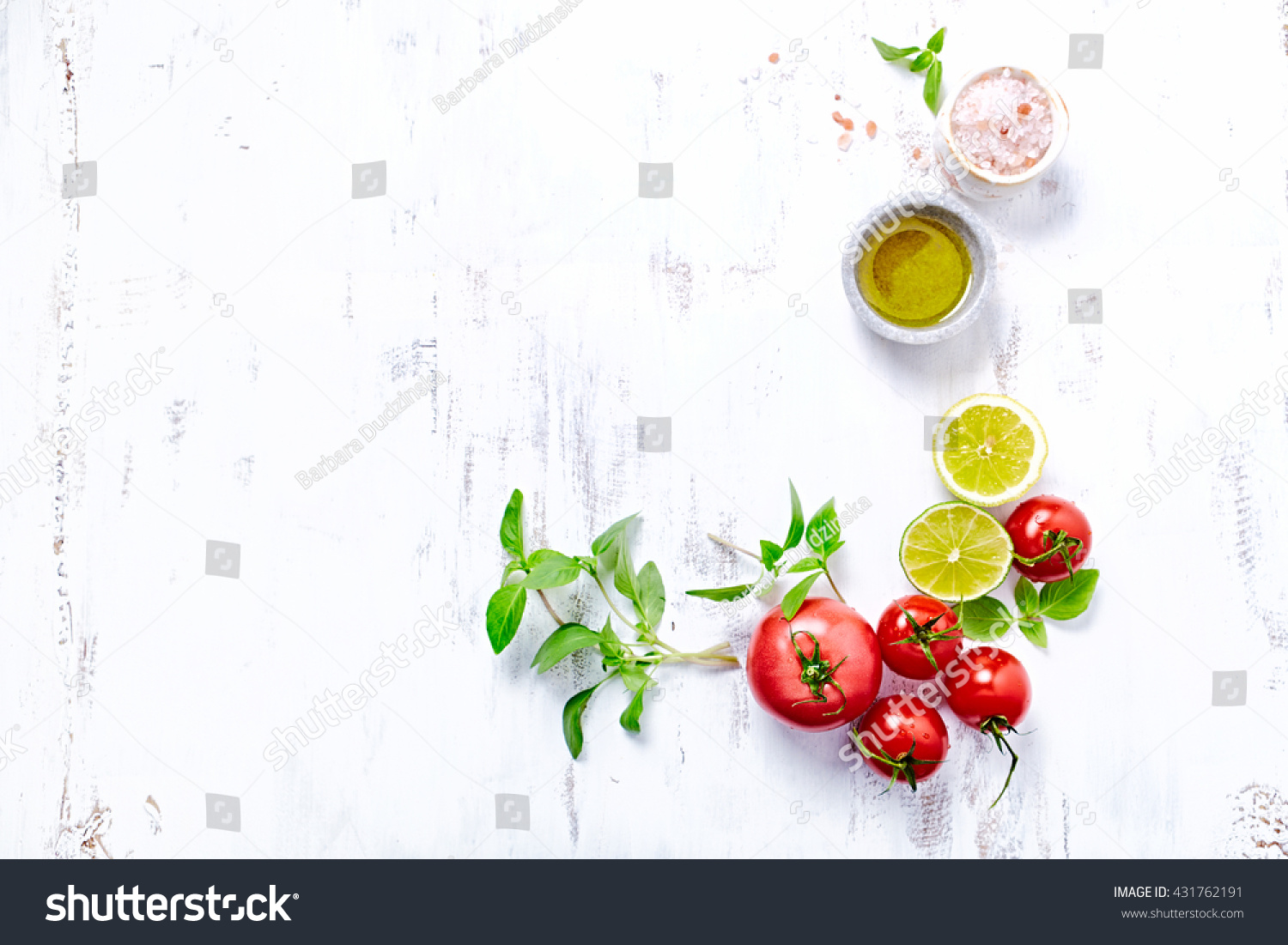 An arrangement of tomatoes, basil, olive oil and himalayan salt. Concept for healthy nutrition. White wooden background. Top view. Copy space.  #431762191