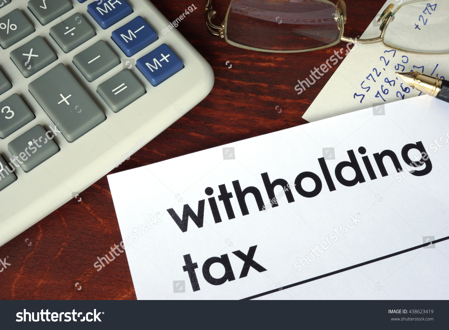 Withholding tax written on a paper.  #438623419