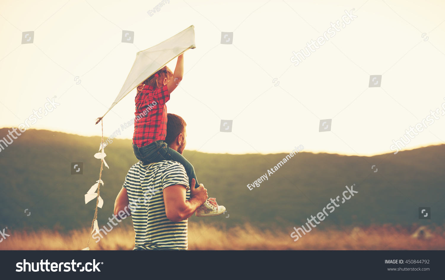 happy family father and child on meadow with a kite in the summer on the nature #450844792