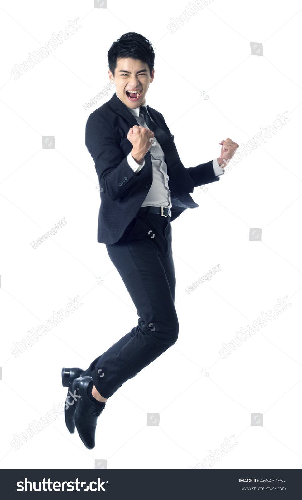 Portrait of young businessman jumping in the air and celebrating his success #466437557