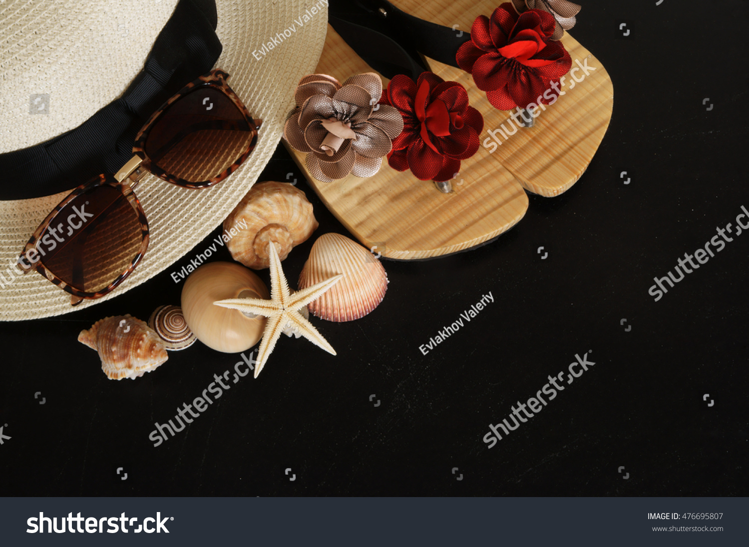 Summer vacation concept, hat, seashells and sunglasses on black grunge background #476695807